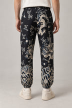 All Over Dragon Print Joggers 'Watatsumi' – black all over dragon print joggers, side view on model