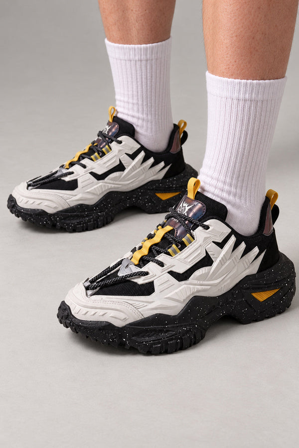 Angular Panel Chunky Sneakers 'Kakuba' – white and black angular panel chunky sneakers with yellow accents, Japanese streetwear sneakers worn with white socks, on model