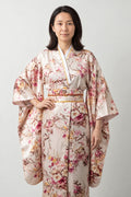 Beige Cherry Blossom Kimono 'Hanafubuki' – beige and pink women's kimono robe with cherry blossom and peacock print and obi sash, long Japanese kimono, front view on model
