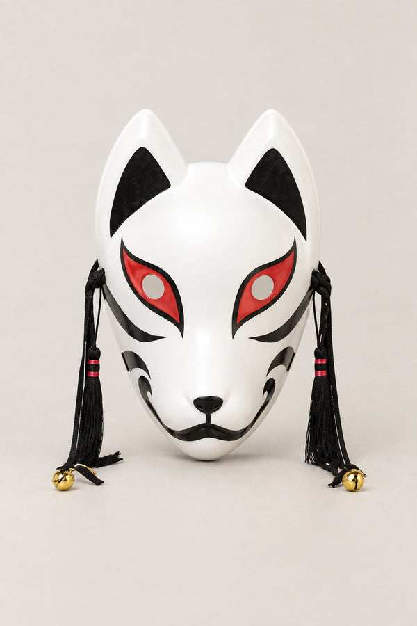 Black and White Fox Mask 'Kurogitsune' – white kitsune fox mask with black markings, red eyes, black tassels and bells, Japanese kitsune festival mask, studio view
