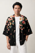 Black Floral Casual Haori 'Chirihana' – black casual haori jacket with pink and green floral print at the hem and shoulders, unisex Japanese kimono cardigan, front view on model