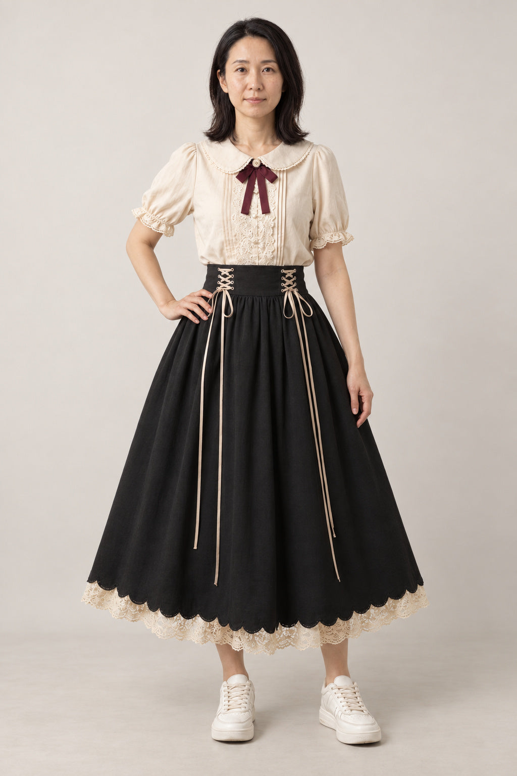 Black Formal Blouse Skirt Set 'Kokutan' – cream puff sleeve blouse with ribbon and black corset-laced full skirt with lace hem, Japanese style formal two-piece, front view on model
