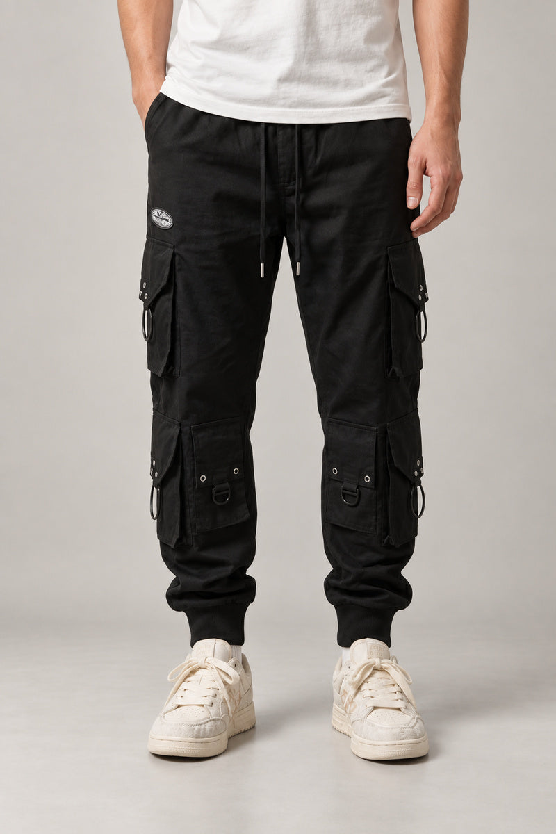 Black Techwear Cargo Pants 'Kageboshi' – black techwear cargo pants with multiple pockets and straps, Japanese streetwear trousers, front view on model