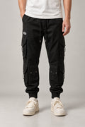 Black Techwear Cargo Pants 'Kageboshi' – black techwear cargo pants with multiple pockets and straps, Japanese streetwear trousers, front view on model