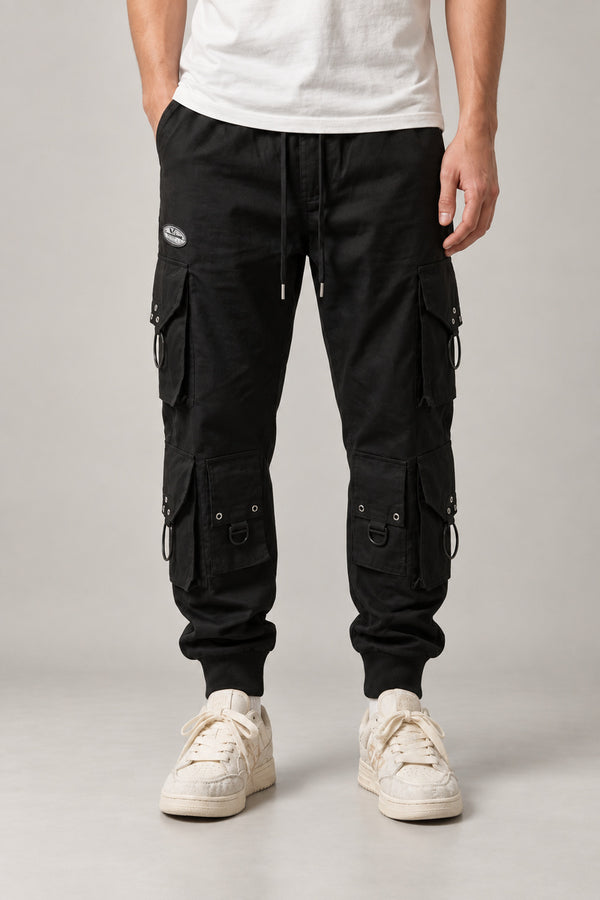 Black Techwear Cargo Pants 'Kageboshi' – black techwear cargo pants with multiple pockets and straps, Japanese streetwear trousers, front view on model