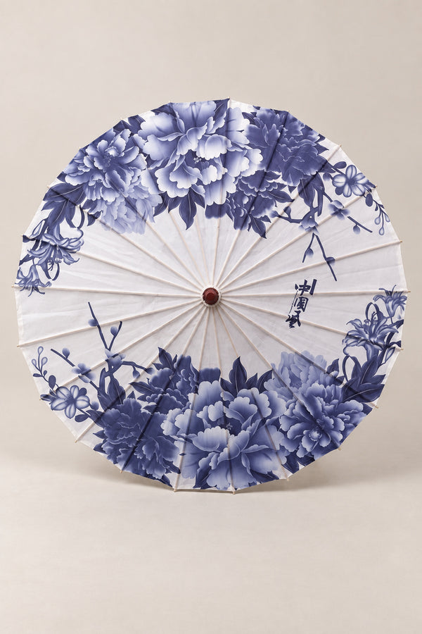 Blue and White Traditional Wagasa 'Aizome' – white parasol printed with indigo peonies at the edge and ink calligraphy, Japanese wagasa parasol with wooden frame and paper-effect canopy, open, studio view