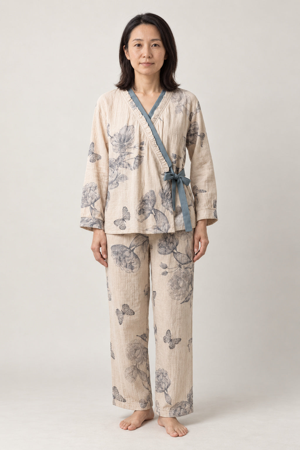 Blue Butterfly Two-Piece Pajamas 'Chouka' – cream women's two-piece pyjamas with blue butterfly print and side-tie top, Japanese style loungewear, front view on model