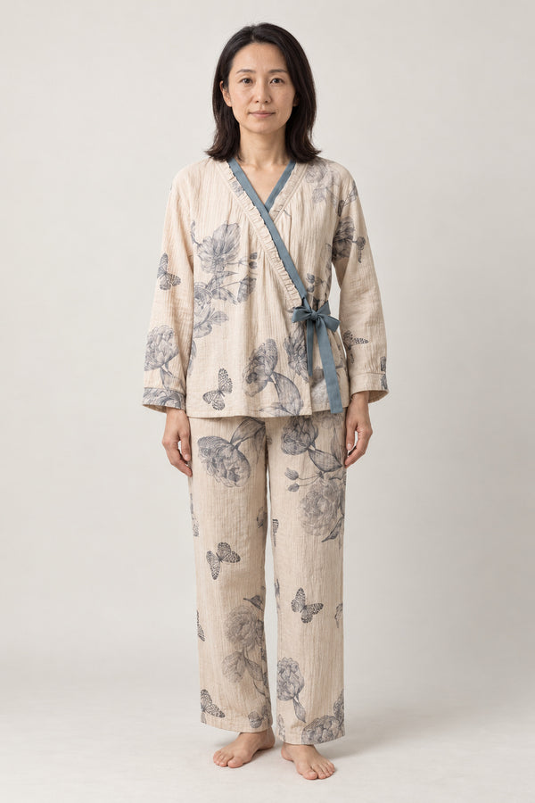 Blue Butterfly Two-Piece Pajamas 'Chouka' – cream women's two-piece pyjamas with blue butterfly print and side-tie top, Japanese style loungewear, front view on model