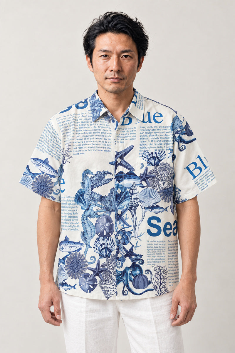 Blue Sea Life Print Shirt 'Umibe' – white short sleeve shirt with blue sea life and lettering print, Japanese streetwear camp collar shirt, front view on model