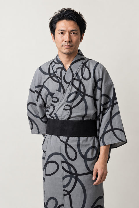 Bold Brushstroke Kimono 'Shodo' – grey men's kimono with bold black calligraphy brushstroke print and black obi belt, Japanese yukata robe, front view on model
