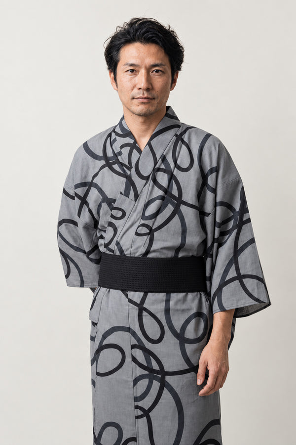 Bold Brushstroke Kimono 'Shodo' – grey men's kimono with bold black calligraphy brushstroke print and black obi belt, Japanese yukata robe, front view on model
