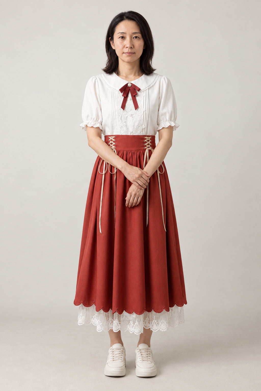 Brick Red Corset Skirt Set 'Taisha' – white puff sleeve blouse with red ribbon and brick red corset-laced skirt with lace hem, Japanese style two-piece outfit, front view on model