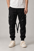 Buckle Strap Techwear Joggers 'Kusari' – black techwear joggers with buckle straps and cargo pockets, Japanese streetwear pants, front view on model