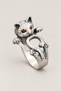 Cat Wrap Ring 'Nemuri' – sterling silver cat ring wrapping round the finger with curled tail and red stone eyes, adjustable Japanese cat ring, studio view