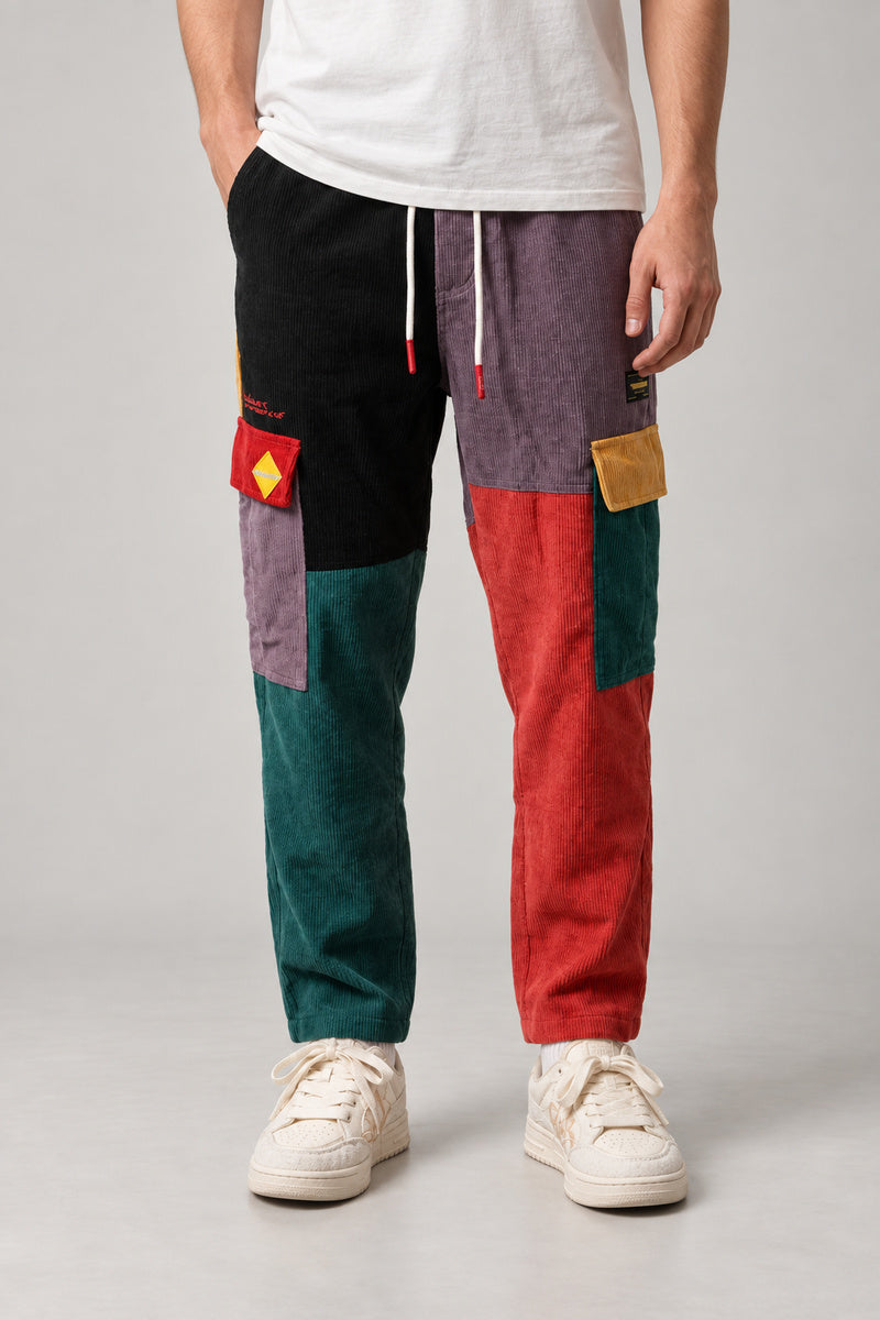 Colour Block Patchwork Trousers 'Tsugiki' – colour block patchwork trousers in black, red, green and purple, Japanese streetwear trousers, front view on model