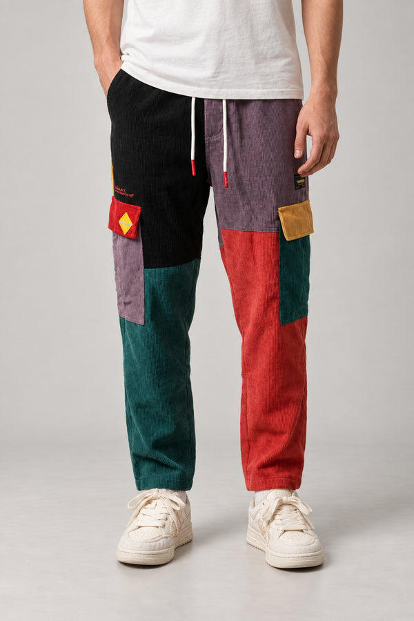 Colour Block Patchwork Trousers 'Tsugiki' – colour block patchwork trousers in black, red, green and purple, Japanese streetwear trousers, front view on model