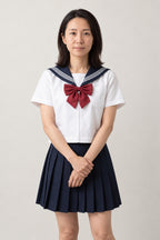 Cream and Navy Seifuku Set 'Azuki' – white short sleeve summer version with navy collar, red bow and navy pleated skirt, front view on model