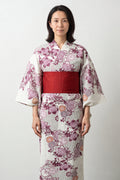 Cream Floral Japanese Kimono 'Hanagoromo' – cream women's kimono with pink cherry blossom print and red obi belt, traditional Japanese yukata, front view on model