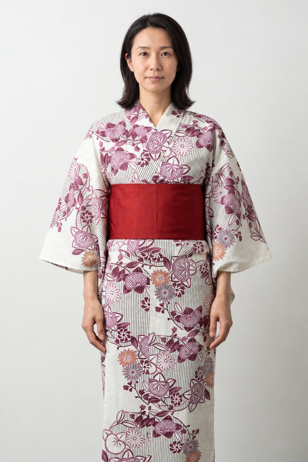 Cream Floral Japanese Kimono 'Hanagoromo' – cream women's kimono with pink cherry blossom print and red obi belt, traditional Japanese yukata, front view on model