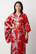 Crimson Peacock Long Kimono 'Shinku' – crimson red women's long kimono robe with peacock and cherry blossom print and obi sash, Japanese satin-look kimono dress, front view on model