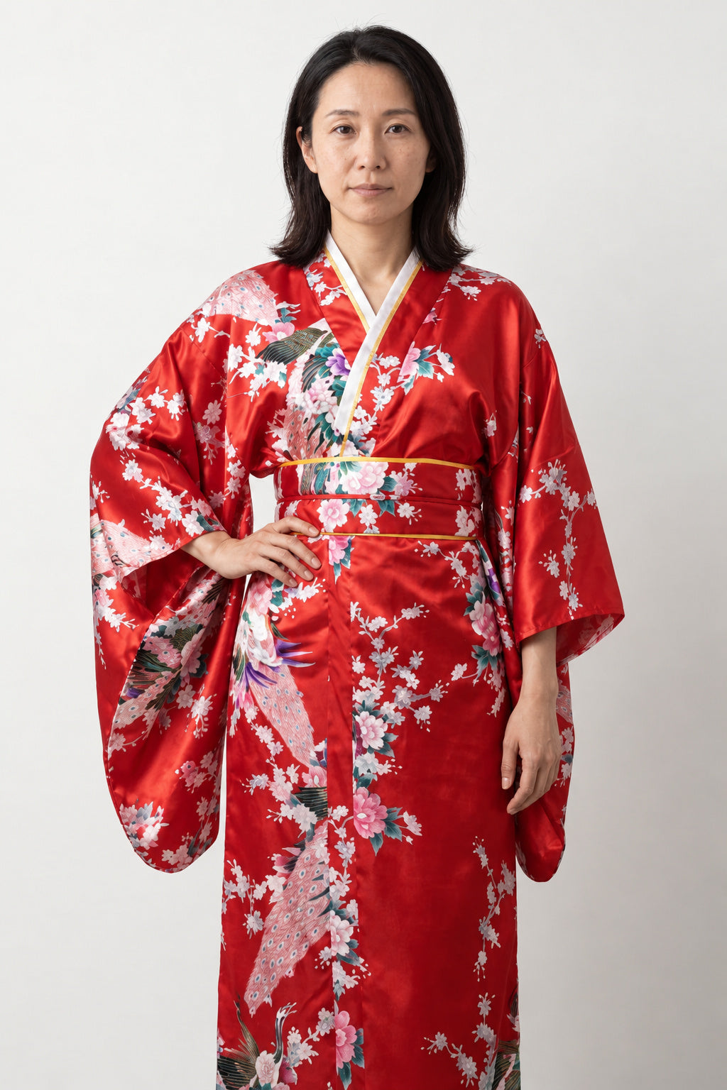Crimson Peacock Long Kimono 'Shinku' – crimson red women's long kimono robe with peacock and cherry blossom print and obi sash, Japanese satin-look kimono dress, front view on model
