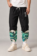Cropped Japanese Print Pants 'Jukkei' – black cropped pants with wave print hem and kanji, front view on model