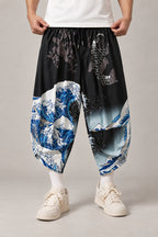 Cropped Japanese Print Pants 'Jukkei' – black cropped pants with great wave and koi print, front view on model