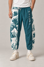 Cropped Japanese Print Pants 'Jukkei' – teal cropped pants with great wave print, front view on model