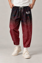 Cropped Japanese Print Pants 'Jukkei' – black to red gradient cropped pants with kanji, front view on model
