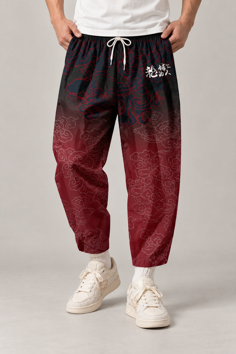 Cropped Japanese Print Pants 'Jukkei' – black to red gradient cropped pants with kanji, front view on model