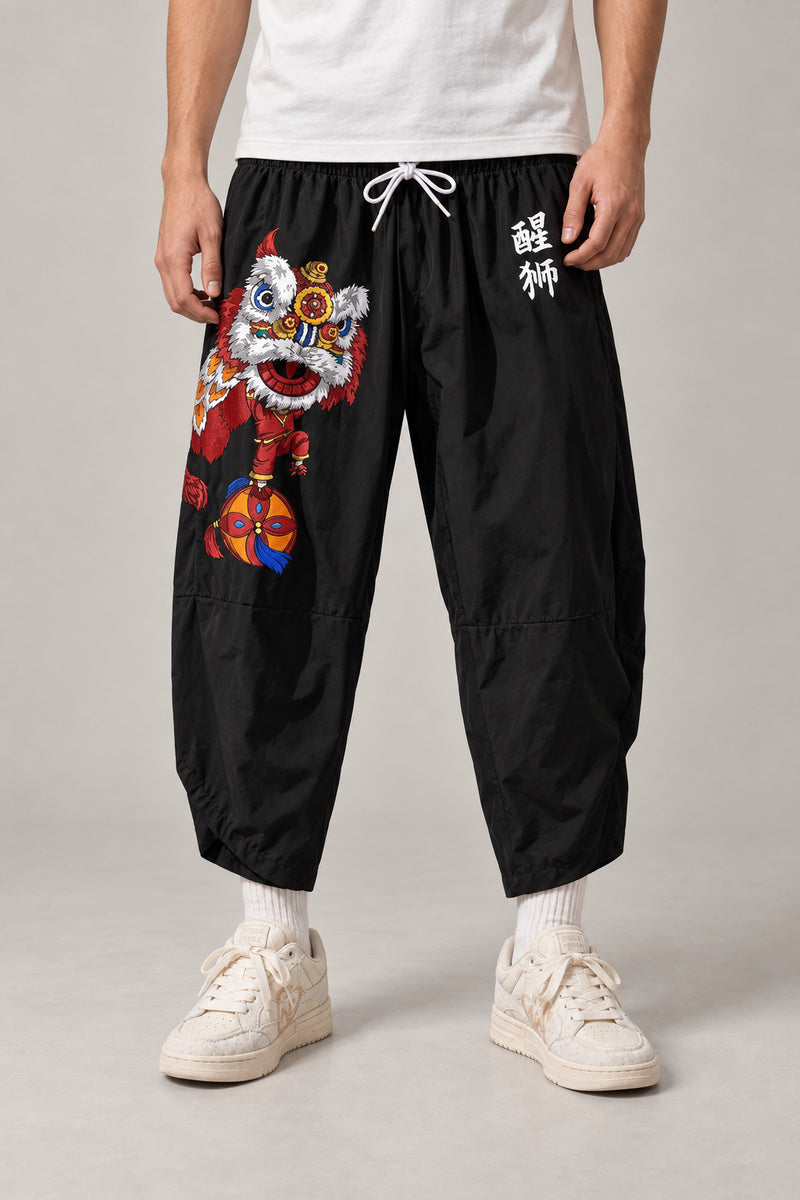 Cropped Japanese Print Pants 'Jukkei' – black cropped pants with shishi lion print, front view on model