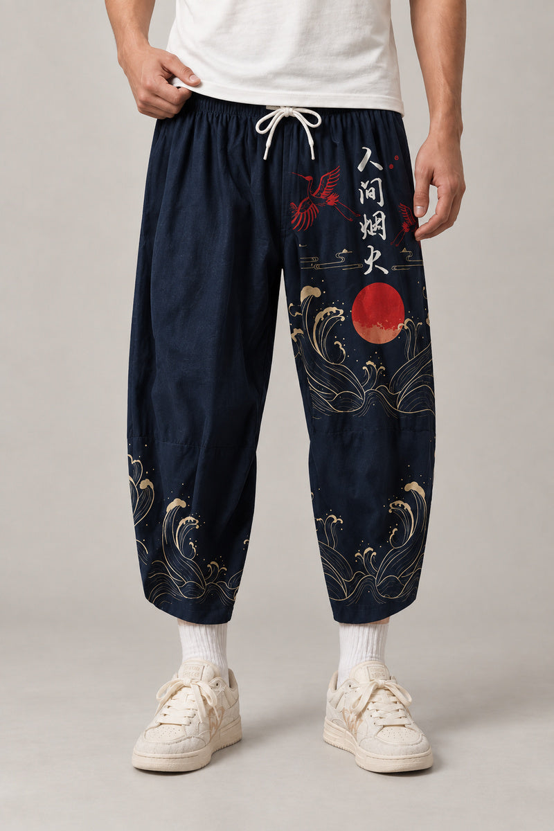 Cropped Japanese Print Pants 'Jukkei' – navy cropped pants with red sun and waves print, front view on model
