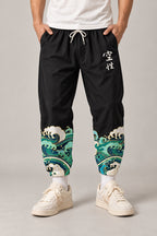 Cropped Japanese Print Pants 'Jukkei' – black cropped pants with wave hem print, front view on model