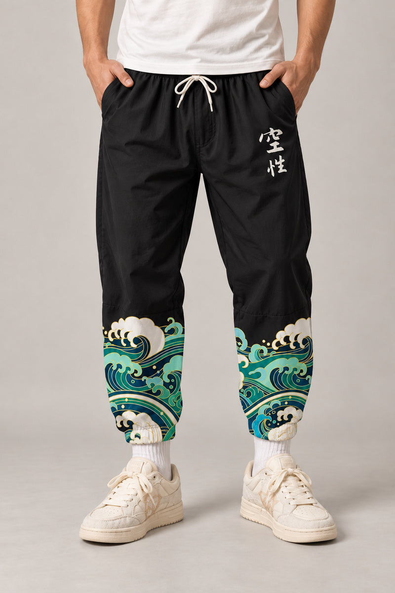 Cropped Japanese Print Pants 'Jukkei' – black cropped pants with wave hem print, front view on model