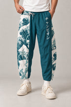 Cropped Japanese Print Pants 'Jukkei' – teal cropped pants with great wave print and Japanese lettering, front view on model