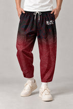 Cropped Japanese Print Pants 'Jukkei' – black to red gradient cropped pants with kanji print, front view on model