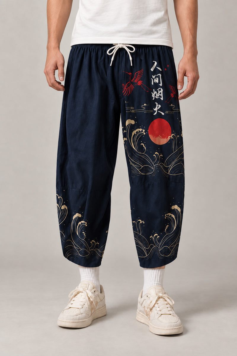 Cropped Japanese Print Pants 'Jukkei' – navy cropped pants with red sun, waves and kanji print, front view on model