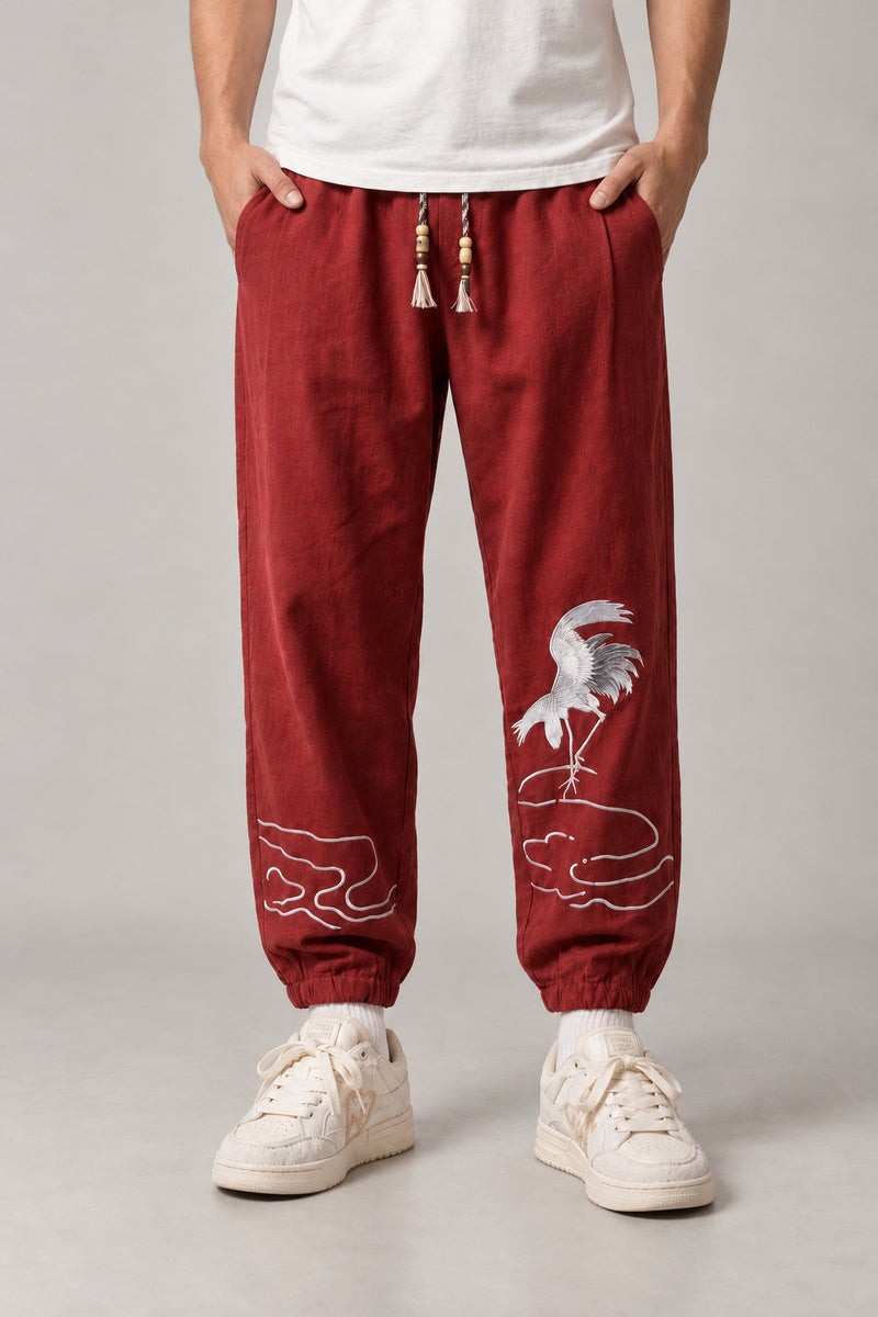 Dancing Crane Jogger Pants 'Sennen' – burgundy dancing crane joggers, side view on model