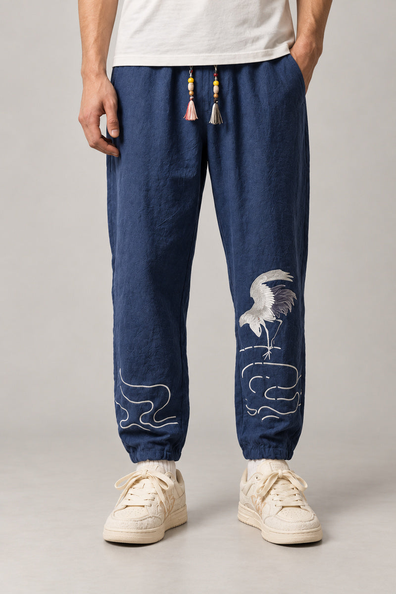 Dancing Crane Jogger Pants 'Sennen' – navy dancing crane joggers, side view on model