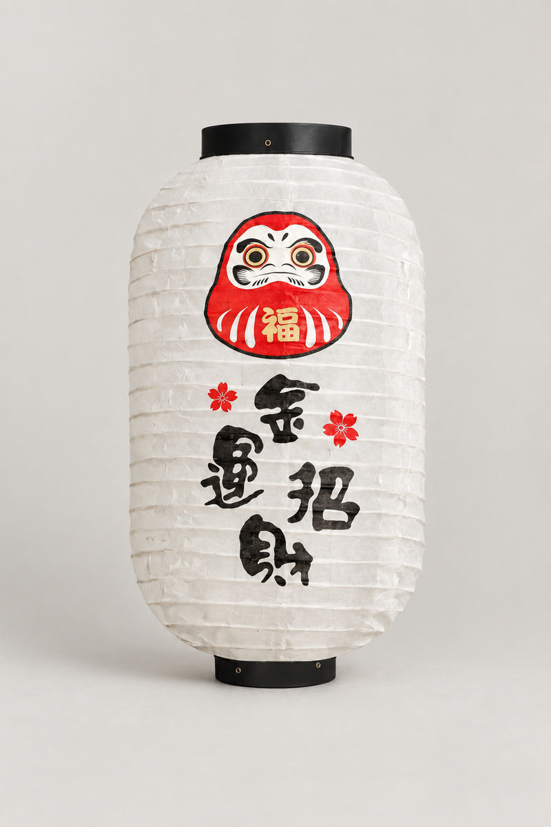Daruma Chochin Paper Lantern 'Fukuakari' – white barrel chochin paper lantern with black rims printed with a red daruma face and brushed kanji, Japanese izakaya lantern, studio view
