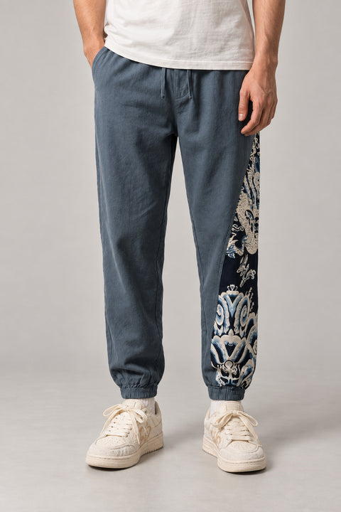 Dragon Panel Wide Leg Pants 'Tatsunami' – slate blue wide leg pants with white dragon print side panel, Japanese streetwear trousers, front view on model