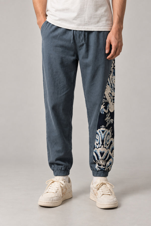 Dragon Panel Wide Leg Pants 'Tatsunami' – slate blue wide leg pants with white dragon print side panel, Japanese streetwear trousers, front view on model