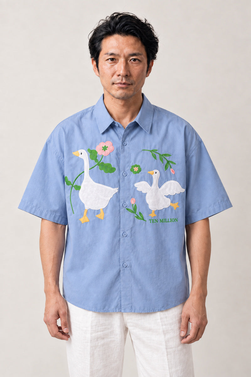Embroidered Goose Shirt 'Gacho' – light blue short sleeve shirt with embroidered geese and flowers, Japanese streetwear camp collar shirt, front view on model