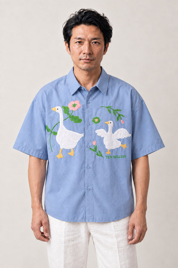 Embroidered Goose Shirt 'Gacho' – light blue short sleeve shirt with embroidered geese and flowers, Japanese streetwear camp collar shirt, front view on model