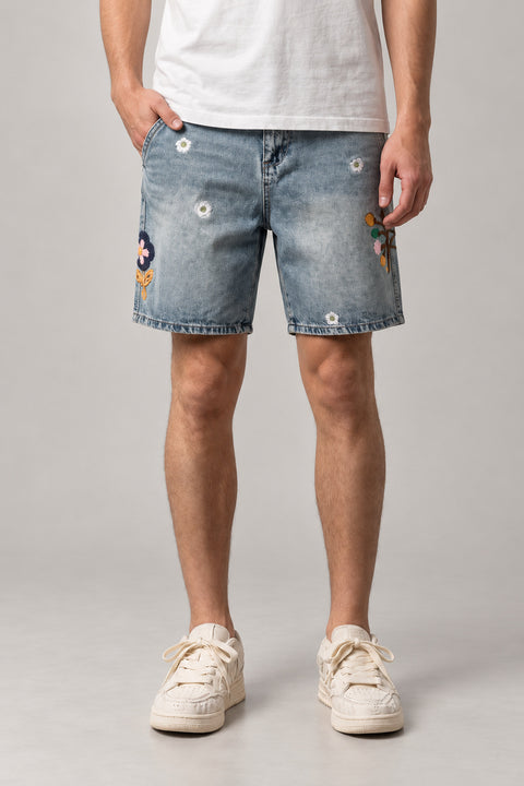 Flower Embroidered Denim Shorts 'Nohana' – light blue denim shorts with embroidered flowers and daisies, Japanese streetwear shorts, front view on model
