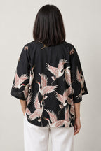 Flying Crane Kimono Jacket 'Usubeni' – back view of black kimono jacket with all-over pink flying cranes print