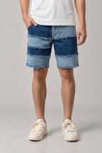 Frayed Seam Patchwork Shorts 'Hotsure' – blue patchwork denim shorts with frayed seams in three washes, Japanese streetwear shorts, front view on model