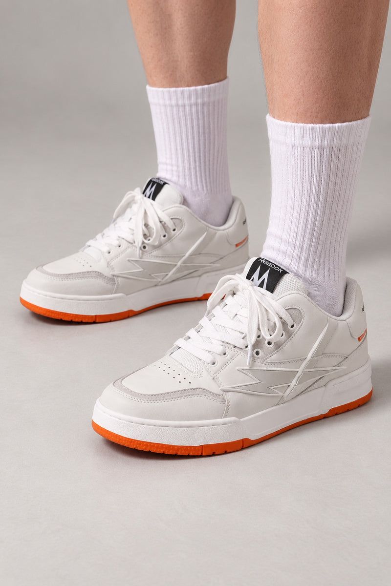 Fuchsia Sole Skate Sneakers 'Ikazuchi' – white version of the skate sneakers on an orange sole, Japanese streetwear sneakers worn with white socks, on model