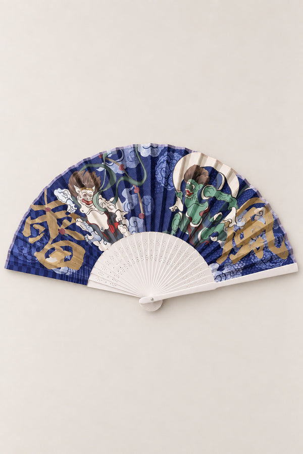 Fujin Raijin Folding Fan 'Kaminari' – folding fan printed with Fujin wind god and Raijin thunder god on navy clouds with gold kanji, Japanese folding sensu fan with bamboo ribs, open, studio view