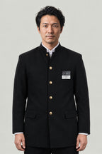 Gakuran 'Tsumeeri' – black gakuran Japanese boys' school uniform jacket with stand collar and gold buttons, front view on model